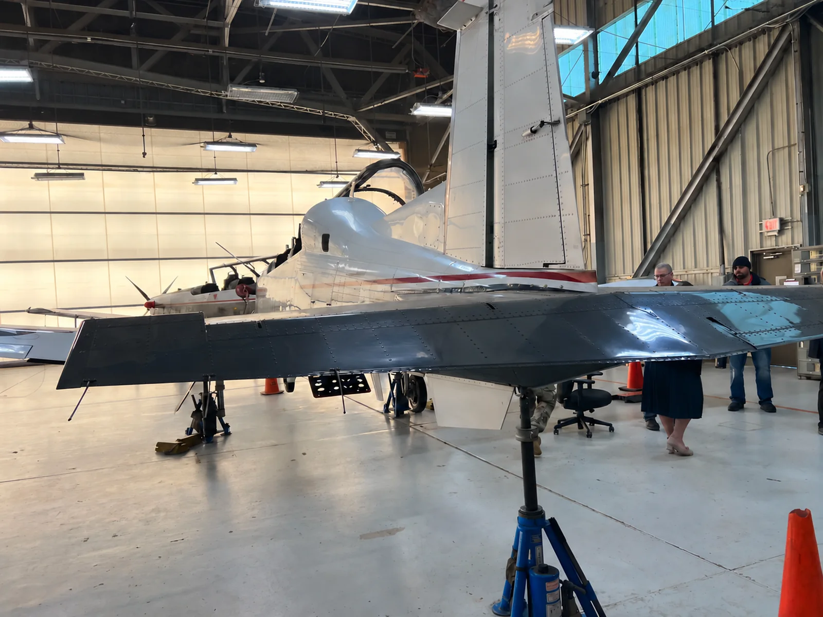T-6 aircraft supported on maintenance jacks in a hangar